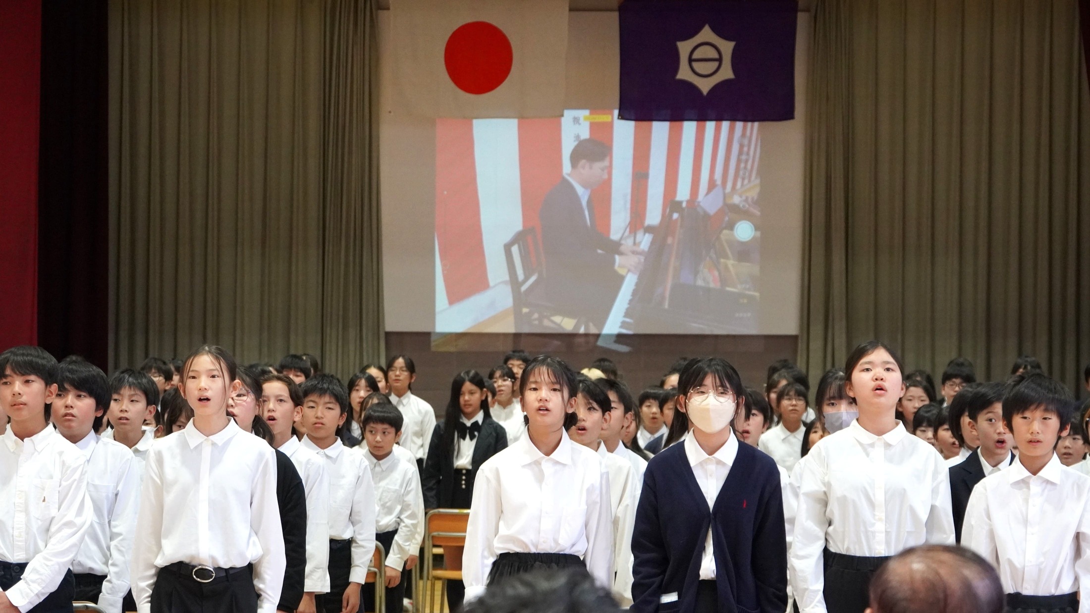 真剣なまなざしで「ずっとずっと 油面の空の下で」を歌う6年生の皆さん。
